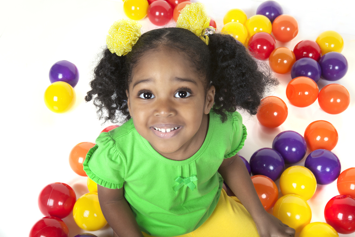pre shcool black smiling female child with colorful balls